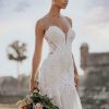 9953 Allure Bridals a Swiss dot pattern, pairs beautifully with the richly beaded and appliquéd strapless bodice of this fit and flare sheath