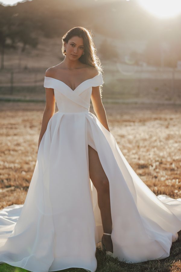 R3602 Allure Romance Crisp, architectural organza softly pleats and tucks along the waist and bodice of this romantic off shoulder gown
