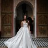 A softly pleated strapless, sweetheart neckline